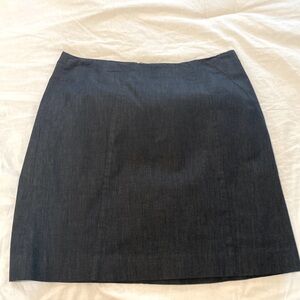 Denim mini skirt with back zipper and clasps.